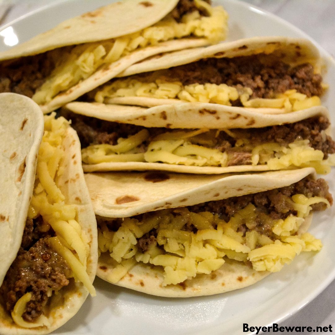 Air Fryer Mini Beef Tacos in the Ninja Foodi is an easy fried taco recipe made with taco seasoned hamburger, cheese and flour or corn tortilla shells. #Tacos #Airfryer #NinjaFoodi #Beef