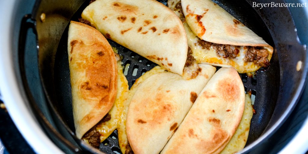 Air Fryer Mini Beef Tacos in the Ninja Foodi is an easy fried taco recipe made with taco seasoned hamburger, cheese and flour or corn tortilla shells. #Tacos #Airfryer #NinjaFoodi #Beef