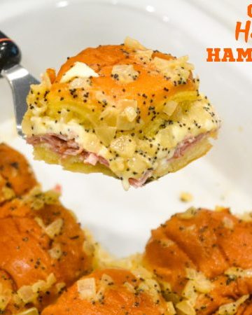 Crock pot Hawaiian roll ham sandwiches are the warm buttery mustard ham sandwich recipe made with onions, poppy seeds, and Swiss cheese without needing to bake them with the same results.