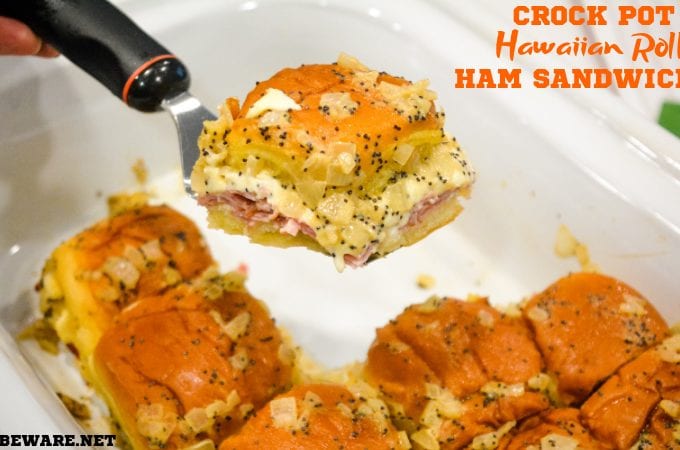 Crock pot Hawaiian roll ham sandwiches are the warm buttery mustard ham sandwich recipe made with onions, poppy seeds, and Swiss cheese without needing to bake them with the same results.
