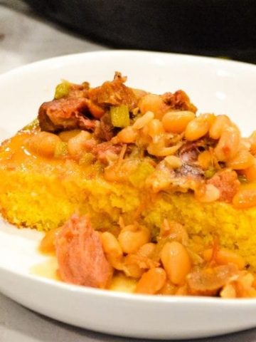 Instant Pot Ham and Beans served over freshly baked cornbread is the ultimate comfort food made in just a fraction of the time compared to a slow cooker.