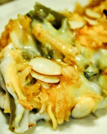 This green bean delight casserole is a dressed-up version of the original green bean casserole with the addition of some cheese and nuts to the recipe.