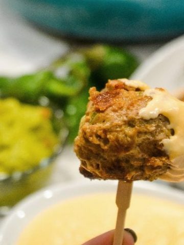 Low-Carb Jalapeno Popper Meatballs combine hamburger with chopped jalapenos, cream cheese, cheddar cheese, and lots of seasoning for the perfect gameday appetizer or quick dinner recipe.