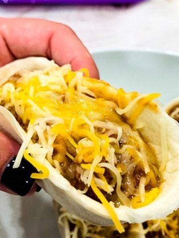 Sloppy Joe Boats is the easy way to eat your sloppy joe recipe without the mess by fill taco boat shells with sloppy joe and topping off with cheese. 