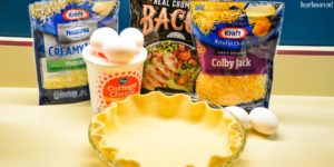 Easy bacon and cheese quiche is made quickly in a blender and poured into a store-bought pie crust that has been filled with bacon and shredded cheese for a velvety smooth quiche.