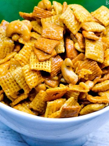 Caramel Cashew Chex Mix is a sweet caramel coated Chex and Golden Graham cereal mix that also includes the buttery and salty addition of cashews.