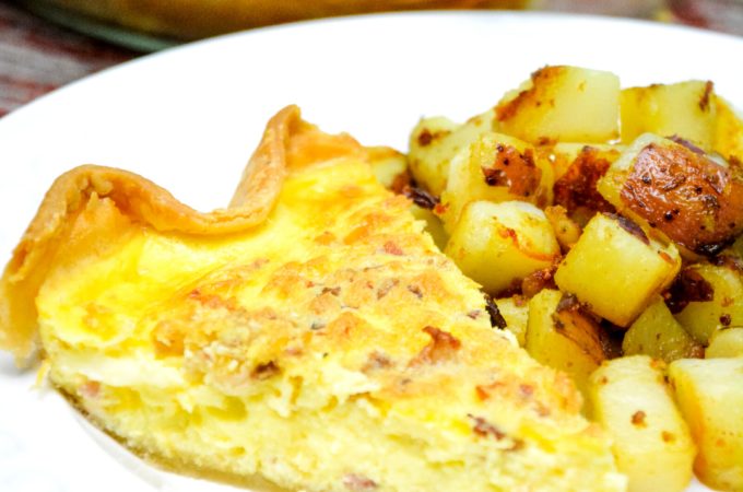 Easy bacon and cheese quiche is made quickly in a blender and poured into a store-bought pie crust that has been filled with bacon and shredded cheese for a velvety smooth quiche.