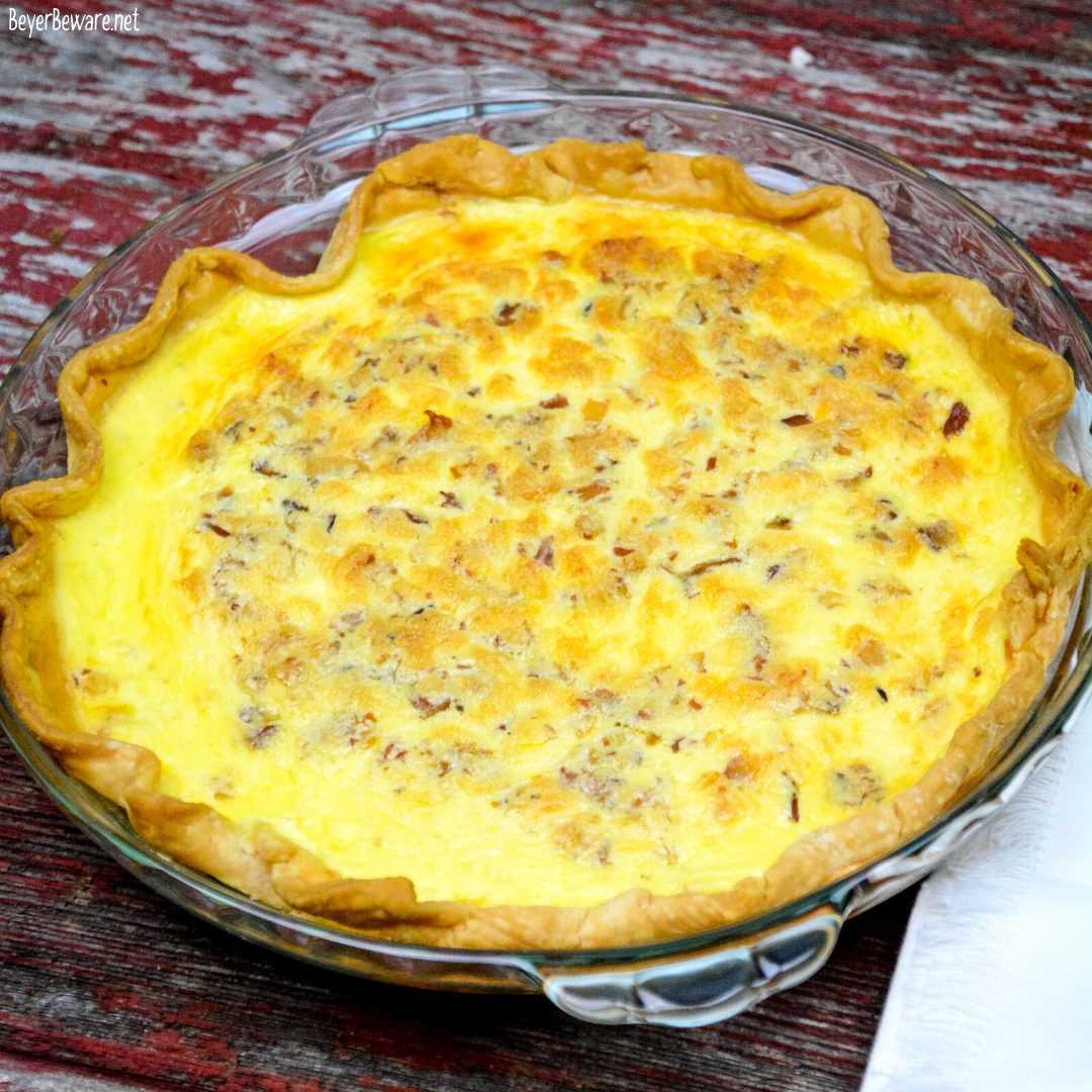 Easy bacon and cheese quiche is made quickly in a blender and poured into a store-bought pie crust that has been filled with bacon and shredded cheese for a velvety smooth quiche.