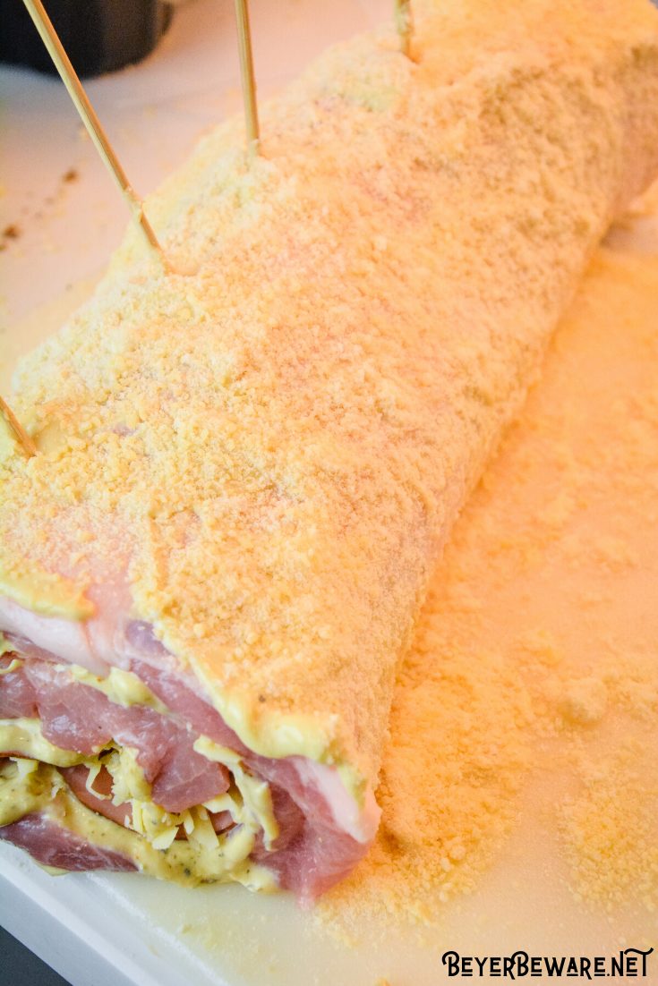 Cordon bleu pork loin recipe is stuffed full of ham and swiss cheese rolled up in a creamy mustard sauce and encrusted in a parmesan crust. 