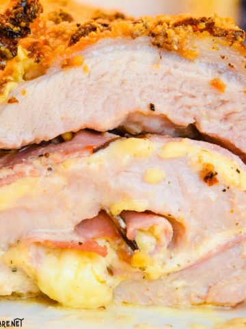 Cordon bleu pork loin recipe is stuffed full of ham and swiss cheese rolled up in a creamy mustard sauce and encrusted in a parmesan crust. 
