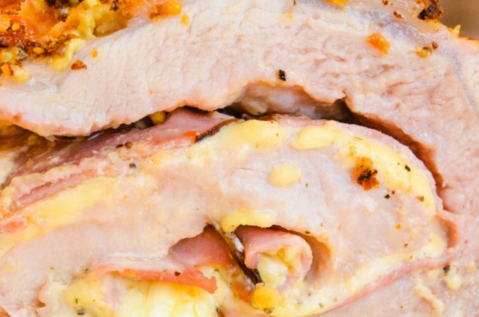 Cordon bleu pork loin recipe is stuffed full of ham and swiss cheese rolled up in a creamy mustard sauce and encrusted in a parmesan crust.