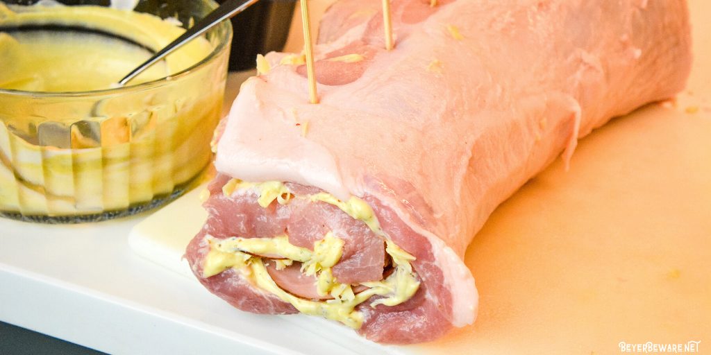 Cordon bleu pork loin recipe is stuffed full of ham and swiss cheese rolled up in a creamy mustard sauce and encrusted in a parmesan crust. 