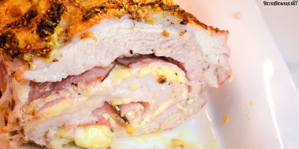 Cordon bleu pork loin recipe is stuffed full of ham and swiss cheese encase in a creamy mustard sauce rolled up in the pork loin and then encrusted in a parmesan crust. 