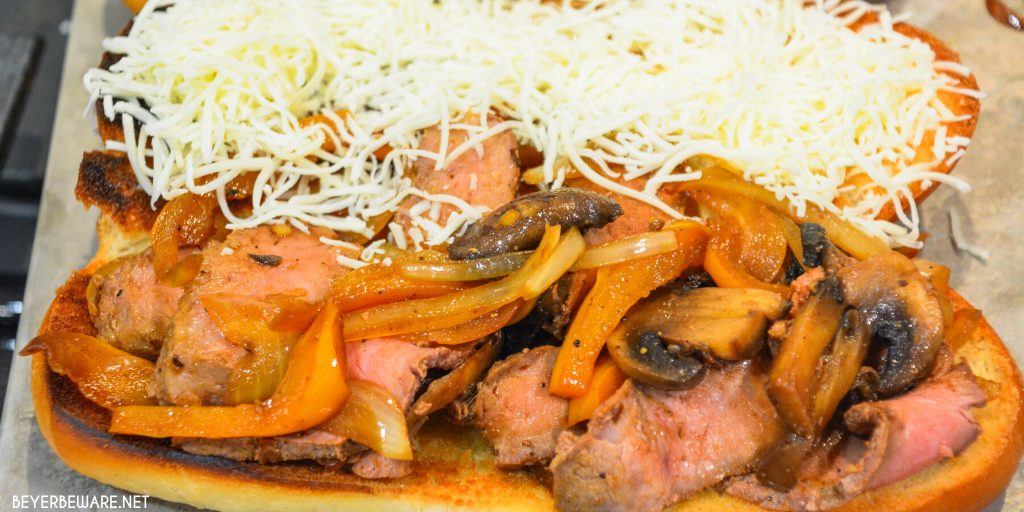 Leftover steak sandwiches uses up cooked steaks to create a midwest version of a Philly Cheesesteak sandwich with caramelized onions, mushrooms, and peppers.