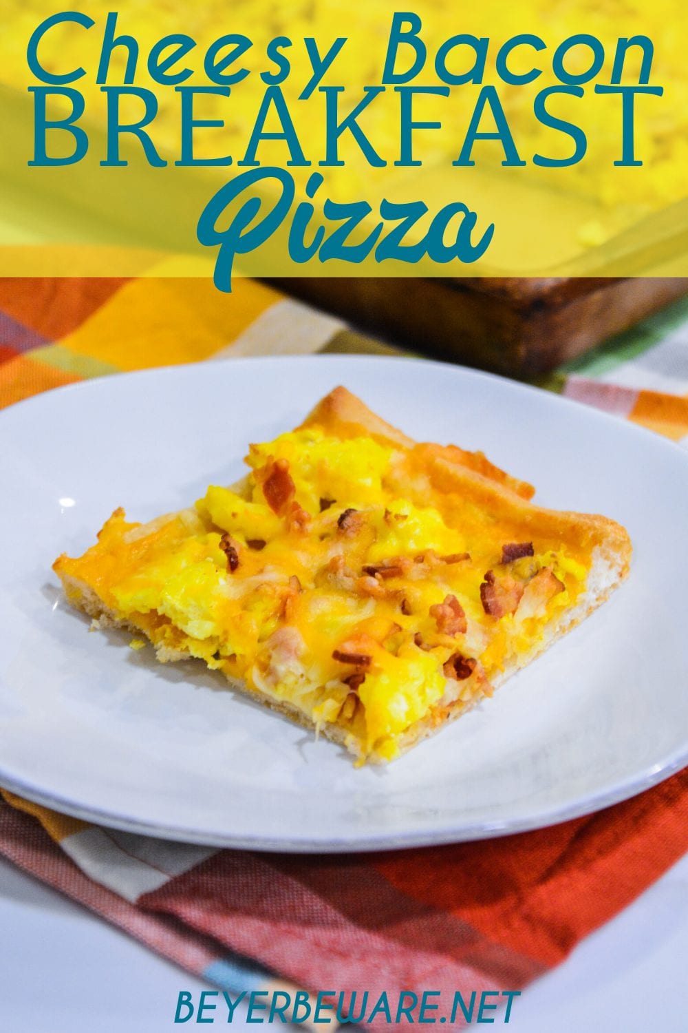 Cheesy bacon breakfast pizza is made with a refrigerated pizza crust, cheese sauce, scrambled egg, and bacon, topped off with more cheese and garlic butter for a decadent breakfast treat.