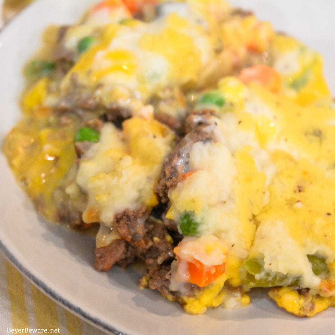 Cheesy Shepherd's Pie is a ground beef casserole filled with mixed vegetables, cheese, cream of mushroom soup, and topped off with mashed potatoes.