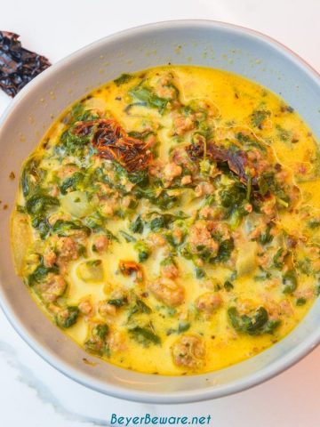 Keto Tuscan sausage soup is a creamy spicy sausage soup with plenty of spinach, sun-dried tomatoes, and spice for an easy and satisfying low-carb soup.