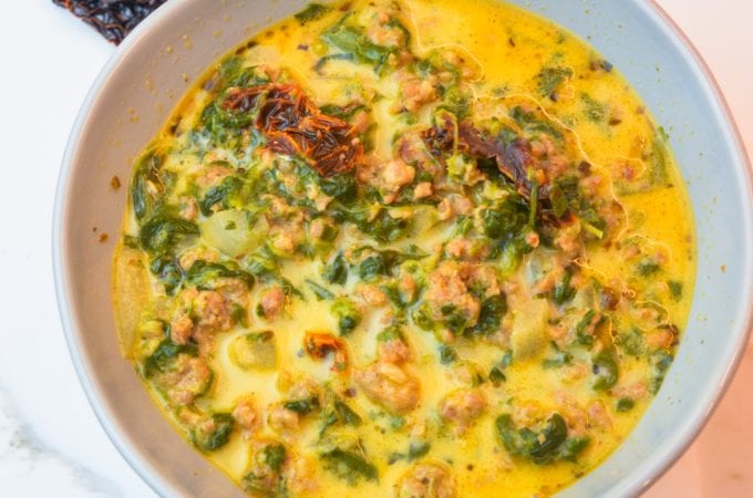 Keto Tuscan sausage soup is a creamy spicy sausage soup with plenty of spinach, sun-dried tomatoes, and spice for an easy and satisfying low-carb soup.