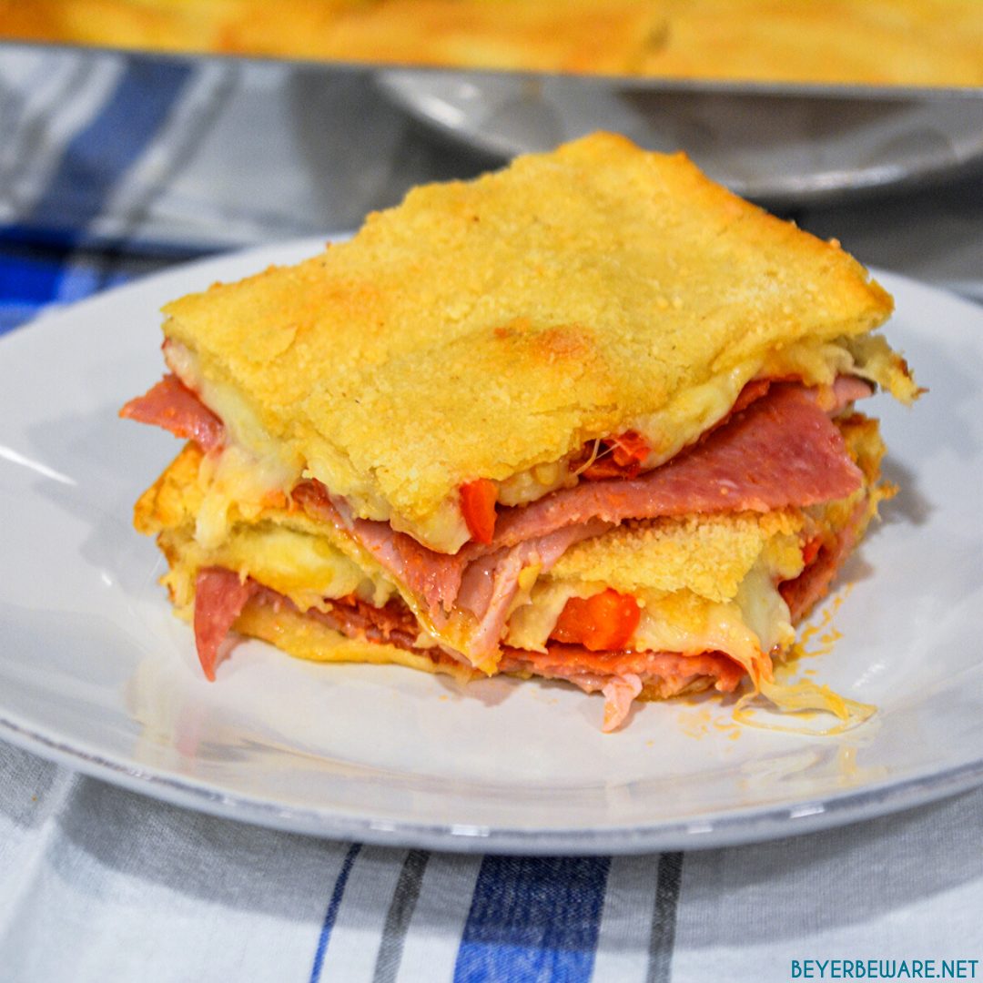 Italian squares are antipasto stuffed crescent rolls that are made with two sheets of a crescent roll dough, ham, salami, pepperoni, pepper rings, and cheese then baked to perfection.