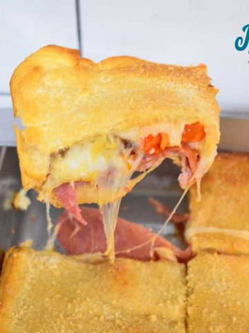 Italian squares are antipasto stuffed crescent rolls that are made with two sheets of a crescent roll dough, ham, salami, pepperoni, pepper rings, and cheese then baked to perfection.