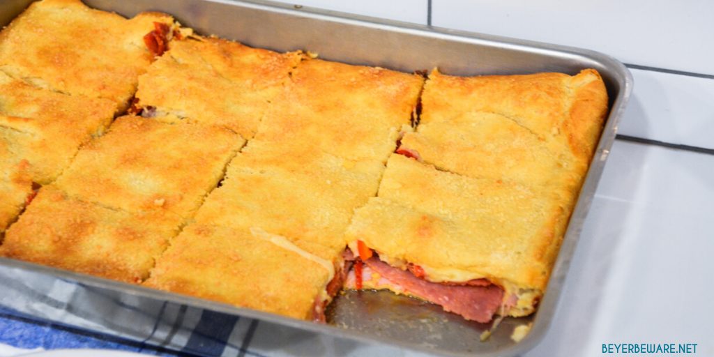 Italian squares are antipasto stuffed crescent rolls that are made with two sheets of a crescent roll dough, ham, salami, pepperoni, pepper rings, and cheese then baked to perfection.