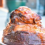 Apricot bourbon-glazed ham on the grill is a sweet and salty combination of flavors with apricot jam, mustard, maple syrup, lemon juice, and bourbon and then smoke drenched on the Big Green Egg.