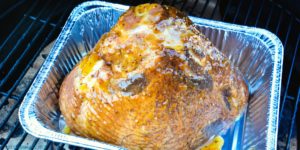 Apricot bourbon-glazed ham on the grill is a sweet and salty combination of flavors with apricot jam, mustard, maple syrup, lemon juice, and bourbon and then smoke drenched on the Big Green Egg.