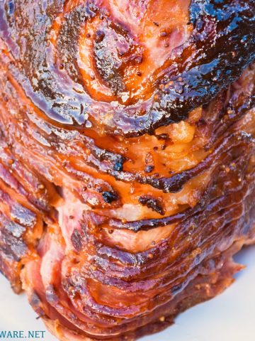 Apricot bourbon-glazed ham on the grill is a sweet and salty combination of flavors with apricot jam, mustard, maple syrup, lemon juice, and bourbon and then smoke drenched on the Big Green Egg.