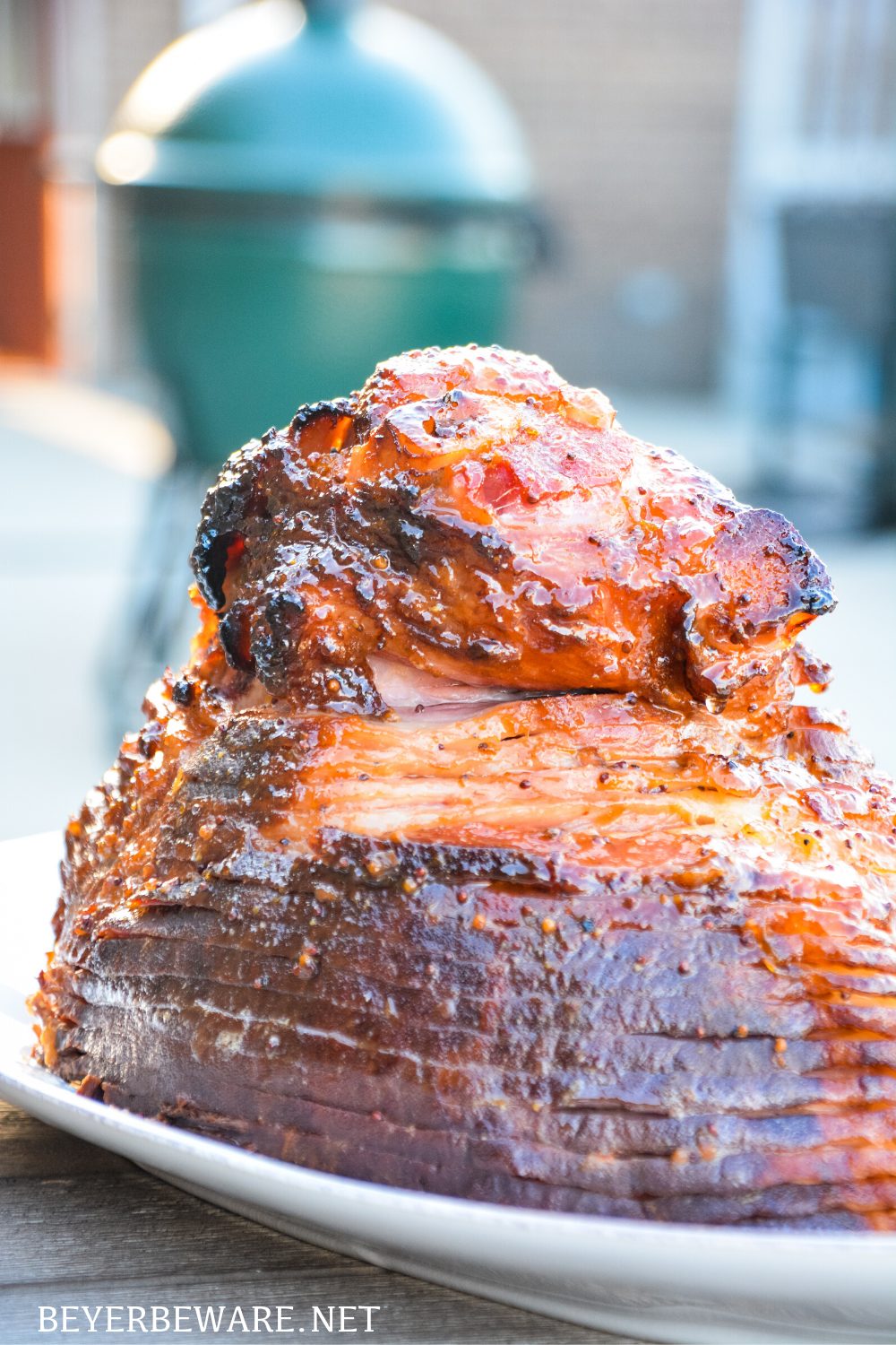 Apricot bourbon-glazed ham on the grill is a sweet and salty combination of flavors with apricot jam, mustard, maple syrup, lemon juice, and bourbon and then smoke drenched on the Big Green Egg.