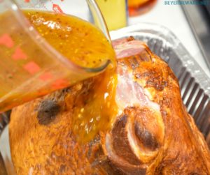 Apricot bourbon-glazed ham on the grill is a sweet and salty combination of flavors with apricot jam, mustard, maple syrup, lemon juice, and bourbon and then smoke drenched on the Big Green Egg.