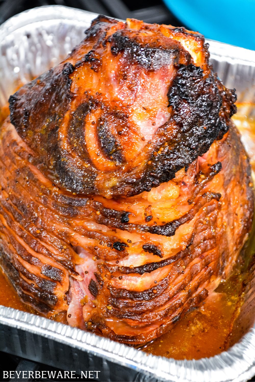 Apricot bourbon-glazed ham on the grill is a sweet and salty combination of flavors with apricot jam, mustard, maple syrup, lemon juice, and bourbon and then smoke drenched on the Big Green Egg.