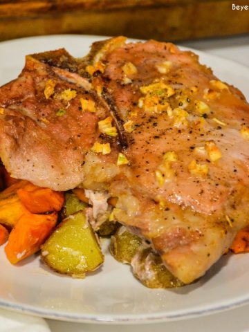 Sheet pan pork chops, sweet potatoes, and red potatoes are a garlic brown sugar pork chops recipe baked on top of roasted sweet potatoes and red potatoes.