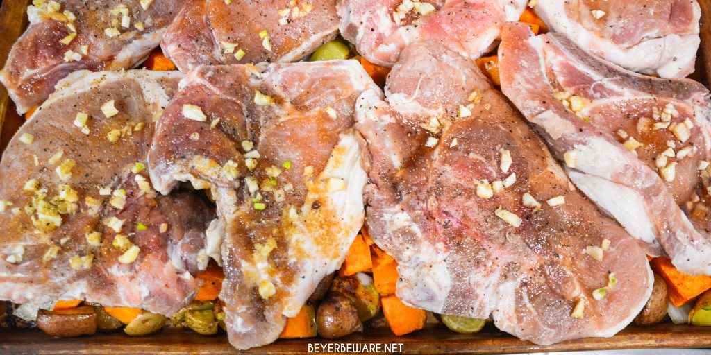 Sheet pan pork chops, sweet potatoes, and red potatoes are a garlic brown sugar pork chops recipe baked on top of roasted sweet potatoes and red potatoes.