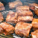 Grilled beef short ribs on the Big Green Egg are smoked with a beef barbecue rub and then slow-cooked to their final temperature in a bath of red wine, butter, and beef broth. 