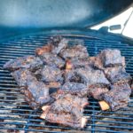 Grilled beef short ribs on the Big Green Egg are smoked with a beef barbecue rub and then slow-cooked to their final temperature in a bath of red wine, butter, and beef broth. 