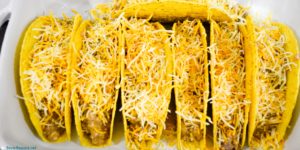 Shredded cheese topped ground beef baked tacos