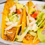 Two ground beef baked tacos with toppings