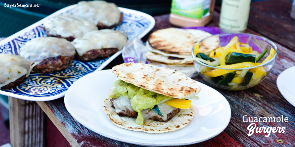 Guacamole burgers combine taco night with burger night straight from the grill with flavorful burgers, pepper-jack cheese, guacamole, sauteed onions, peppers, and street taco tortilla shells.