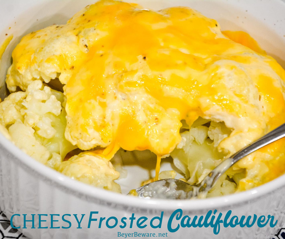 Cheesy Frosted Cauliflower is a whole head of cauliflower, steamed and then frosted with a combination of mayonnaise and mustard and then covered in cheese before quickly roasting in the oven.