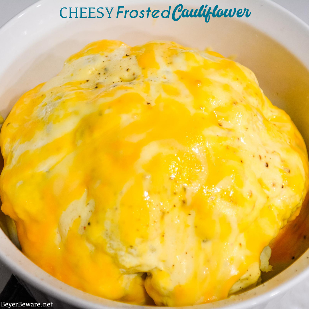 Cheesy Frosted Cauliflower is a whole head of cauliflower, steamed and then frosted with a combination of mayonnaise and mustard and then covered in cheese before quickly roasting in the oven.