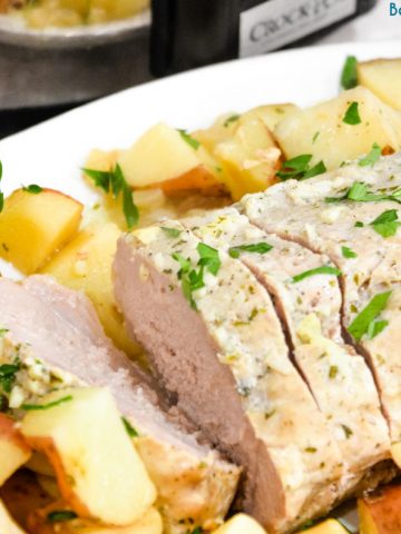 Crock pot pork loin roast and potatoes is an easy dump and go crock pot pot ranch pork loin recipe that will look and taste fancy when you serve it for dinner.