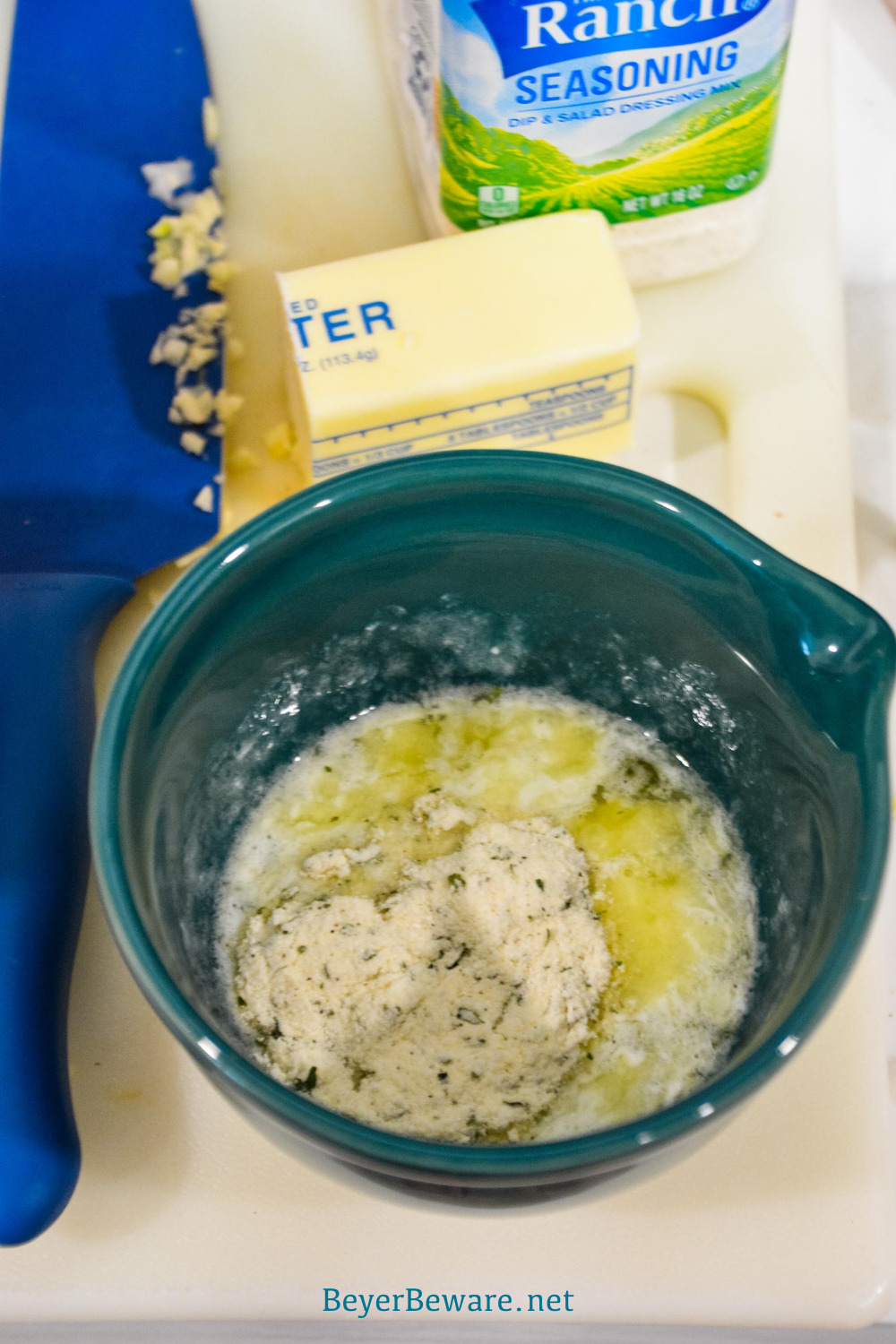 Melted butter with ranch seasoning for ranch pork loin and potatoes.