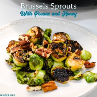 Brussels sprouts with pecans and honey is a cast iron skillet brussels sprout recipe that is a little sweet, nutty with a light cream sauce that is topped off with a drizzle honey.