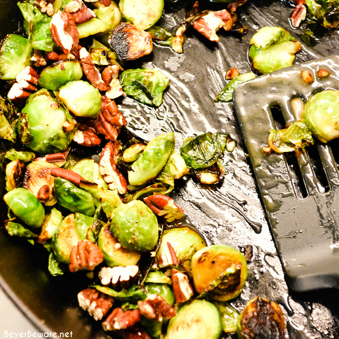 Brussels sprouts with pecans and honey is a cast iron skillet brussels sprout recipe that is a little sweet, nutty with a light cream sauce that is topped off with a drizzle honey.
