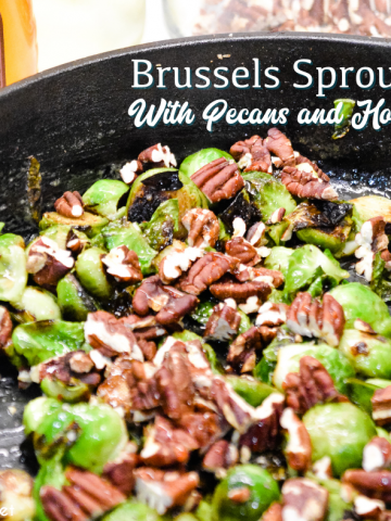 Brussels sprouts with pecans and honey is a cast iron skillet brussels sprout recipe that is a little sweet, nutty with a light cream sauce that is topped off with a drizzle honey.