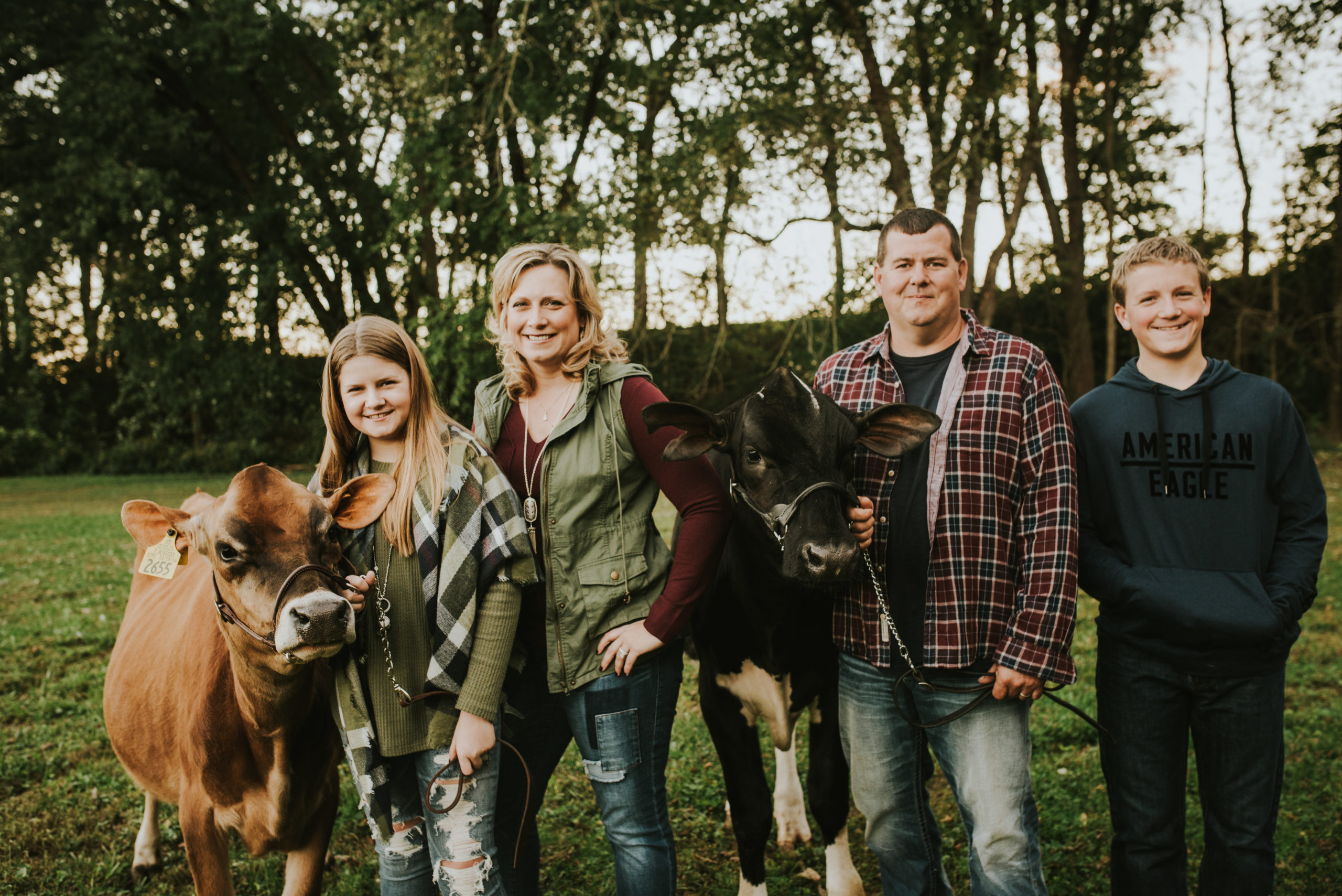 Beyer Family photo with Jersey and holstein calves