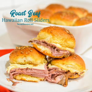 Roast beef Hawaiian roll sliders, or more affectionately called Sandy's Sandwiches, combine butter, garlic powder, worcestershire sauce, and poppy seeds for a butter glaze that compliments these baked roast beef and cheese sandwiches.