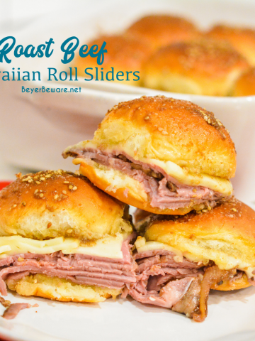 Roast beef Hawaiian roll sliders, or more affectionately called Sandy's Sandwiches, combine butter, garlic powder, worcestershire sauce, and poppy seeds for a butter glaze that compliments these baked roast beef and cheese sandwiches.