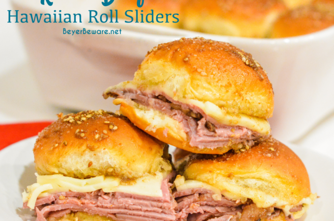 Roast beef Hawaiian roll sliders, or more affectionately called Sandy's Sandwiches, combine butter, garlic powder, worcestershire sauce, and poppy seeds for a butter glaze that compliments these baked roast beef and cheese sandwiches.