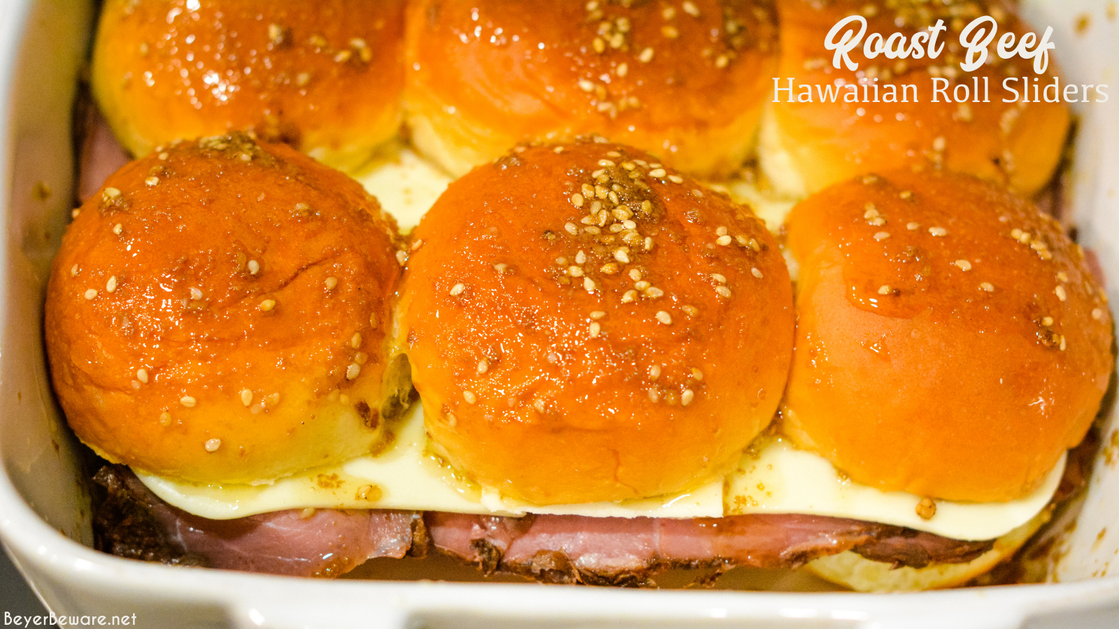 Roast beef Hawaiian roll sliders, or more affectionately called Sandy's Sandwiches, combine butter, garlic powder, worcestershire sauce, and poppy seeds for a butter glaze that compliments these baked roast beef and cheese sandwiches.